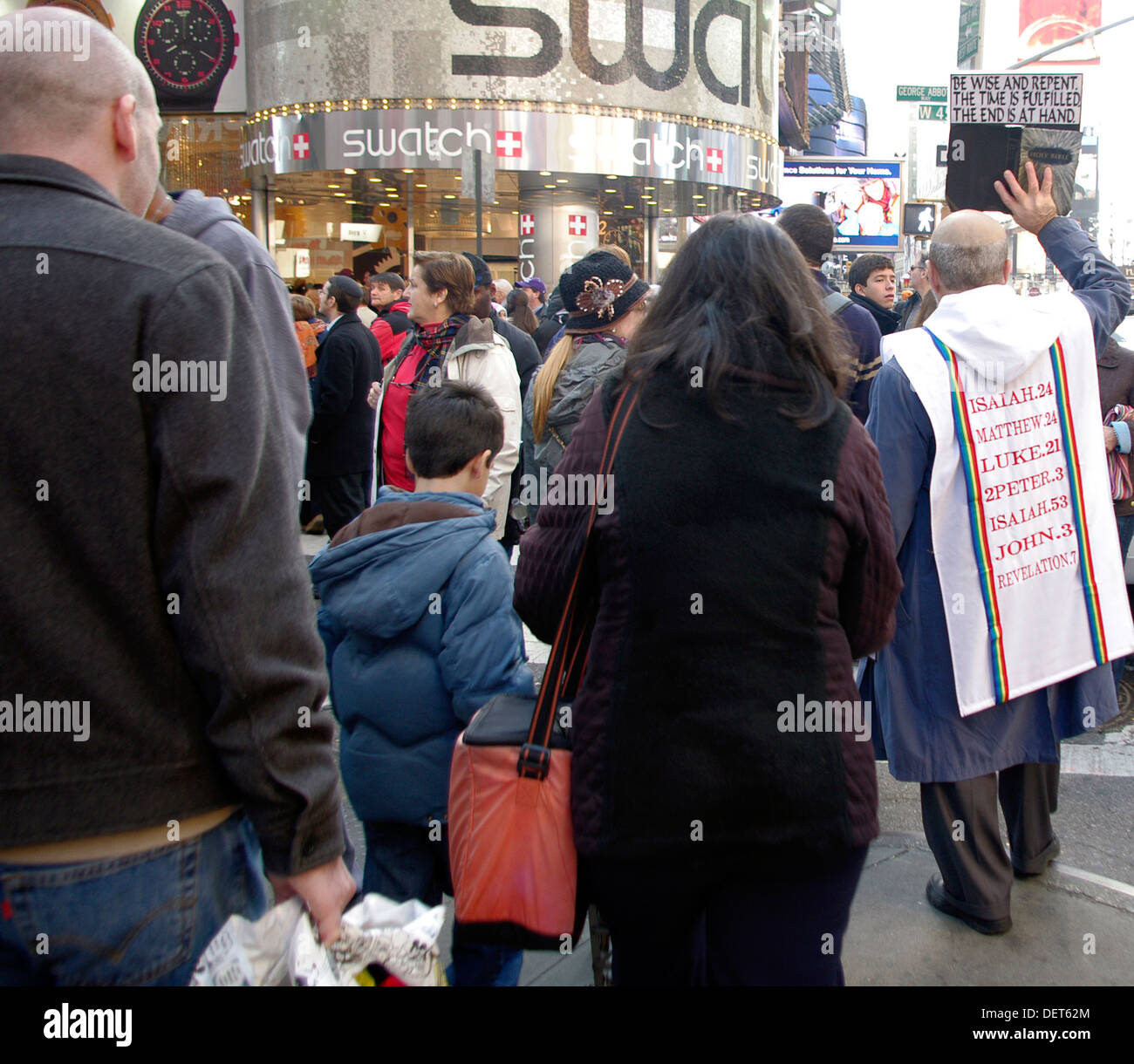 Crowds of shoppers, tourists and a messenger of God congesting the streets in and around Times Square New York City. Stock Photo