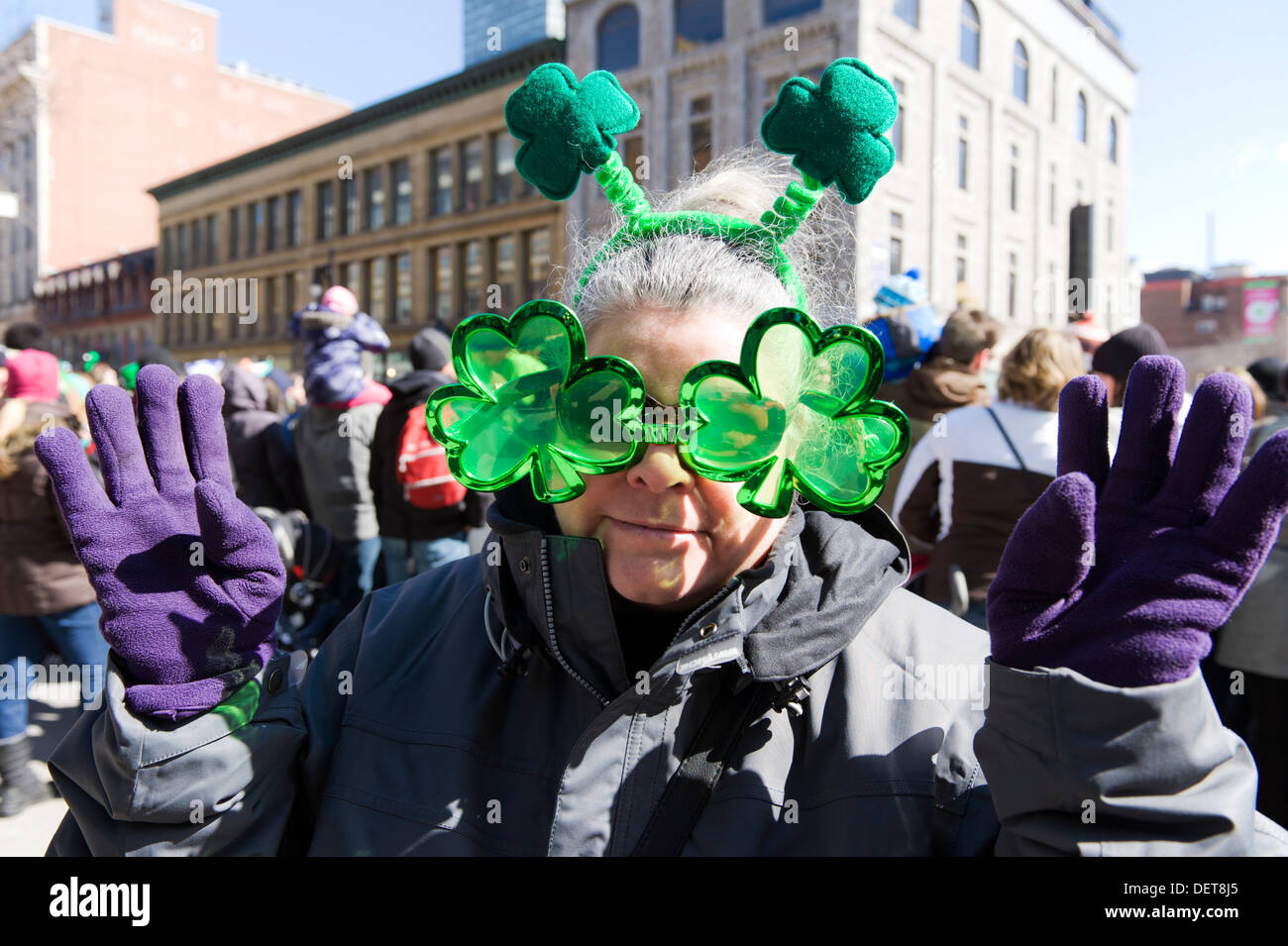 Woman wearing Irish shamrock sunglasses and antennas at the St-Patricks day parade in Montreal, province of Quebec, Canada. Stock Photo