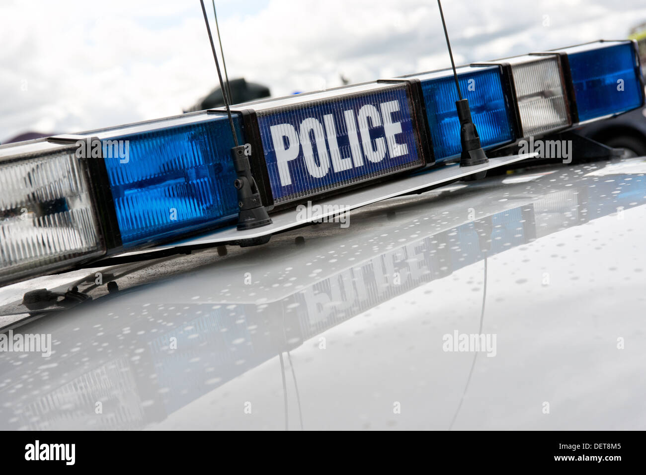 Blue & clear flashing light array with communication aerials on a the roof of a British police car Stock Photo