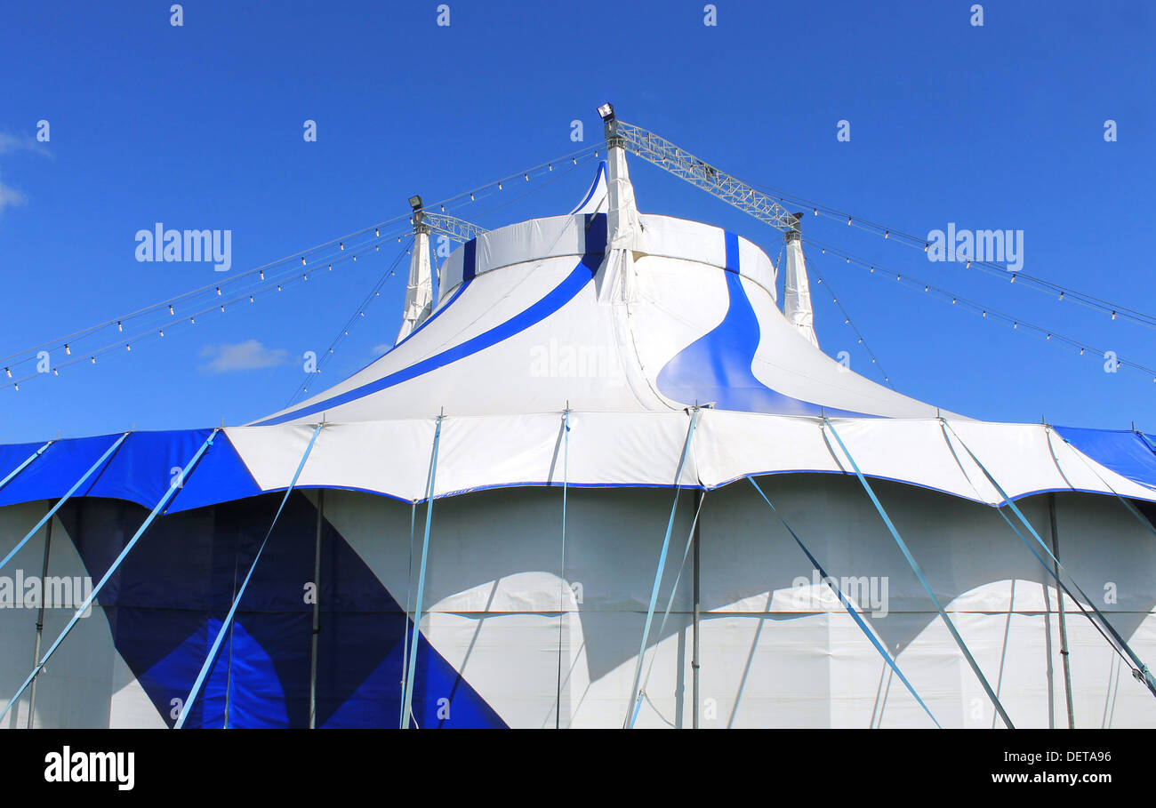 Blue and white big top circus tent with sky background. Stock Photo
