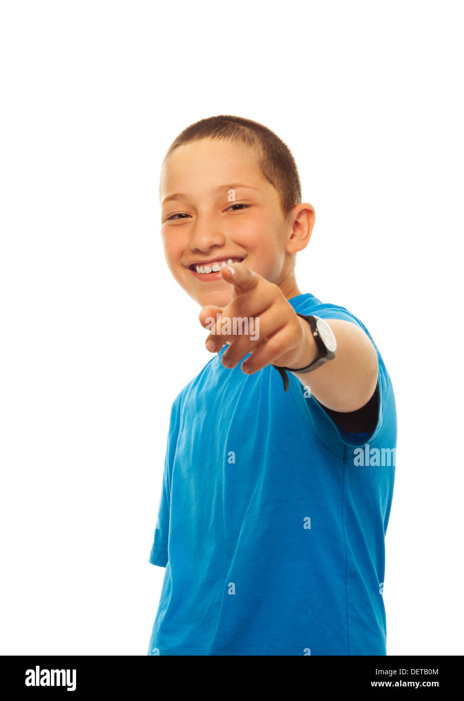 Portrait of happy young boy pointing at camera with his finger, standing isolated on white Stock Photo