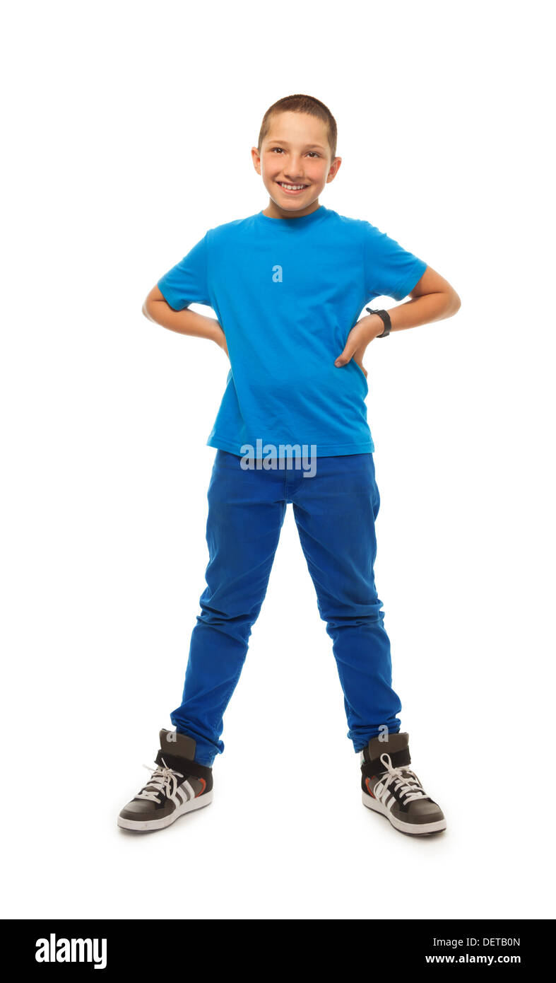 Full height portrait of happy young boy standing isolated on whtie with hand on hips Stock Photo