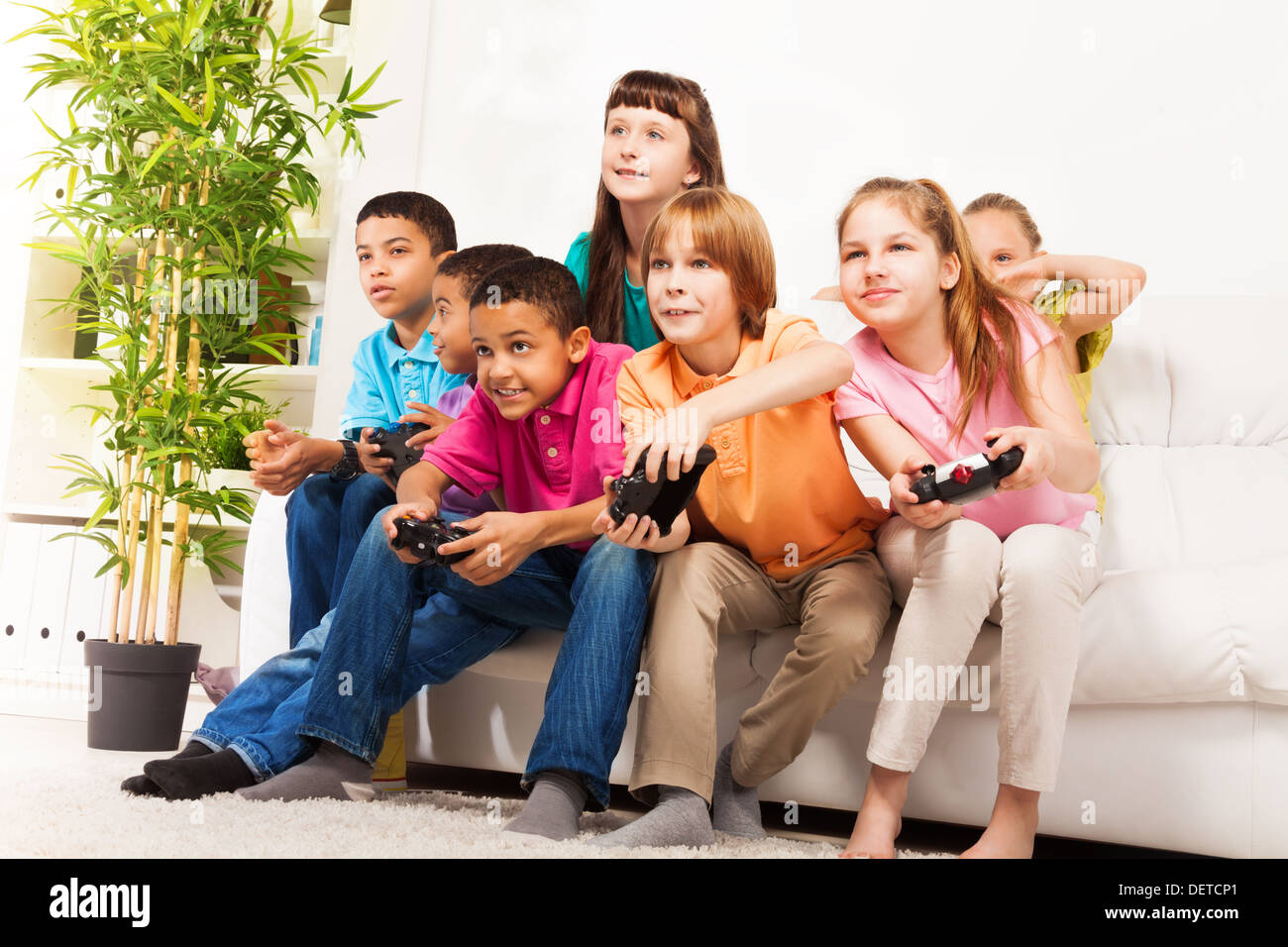 Children group play video game hi-res stock photography and images - Alamy, image size:1300x956