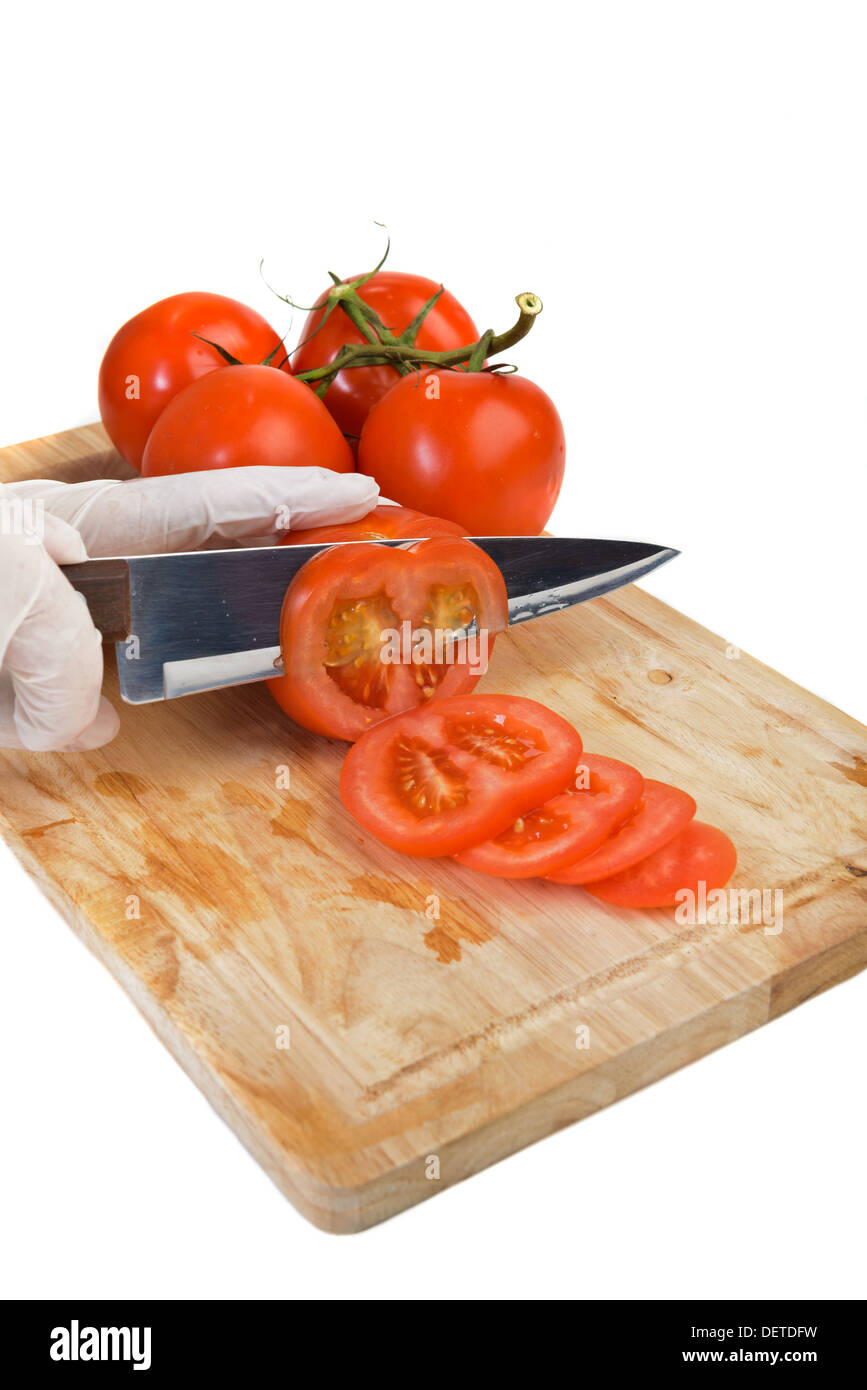 Chopping tomato on kitchen board Stock Photo