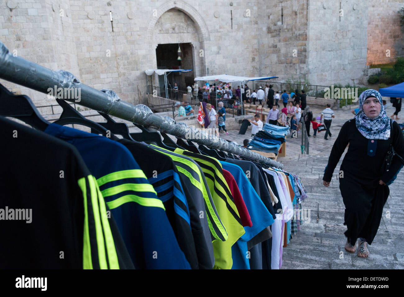 Palestinian woman at Damascus gate with T shirts for sale. Jerusalem Old City. Israel. Stock Photo