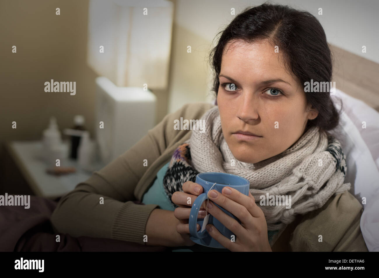 Portrait of woman having flu sore throat drinking tea Stock Photo