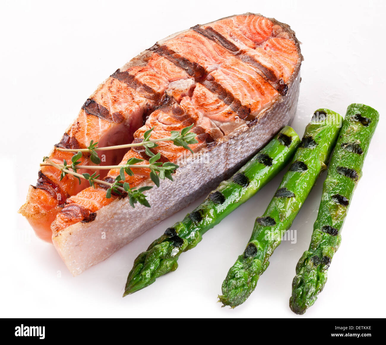 Grilled salmon and asparagus on a white background. Stock Photo