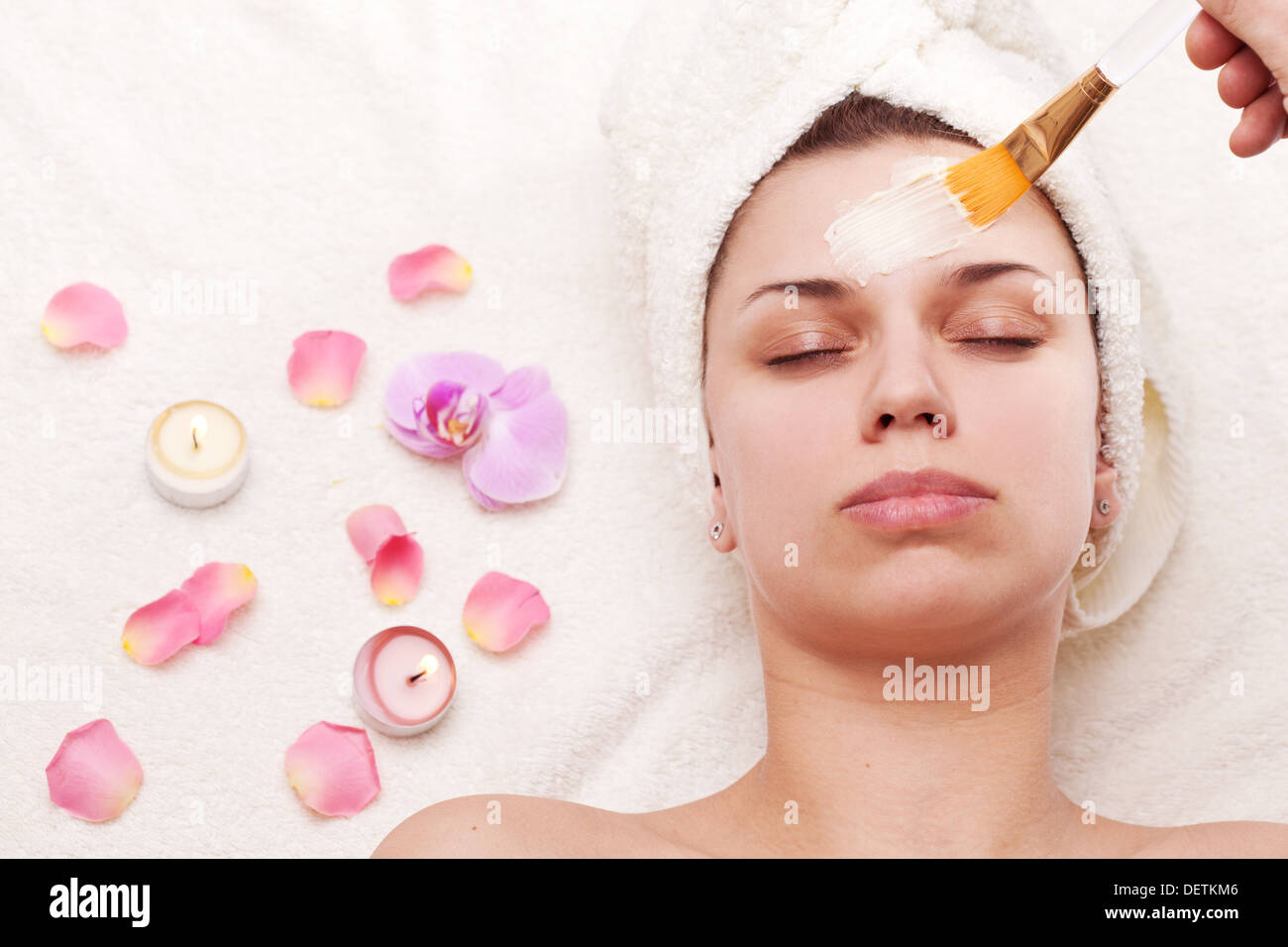Young woman with facial mask in beauty salon. Stock Photo