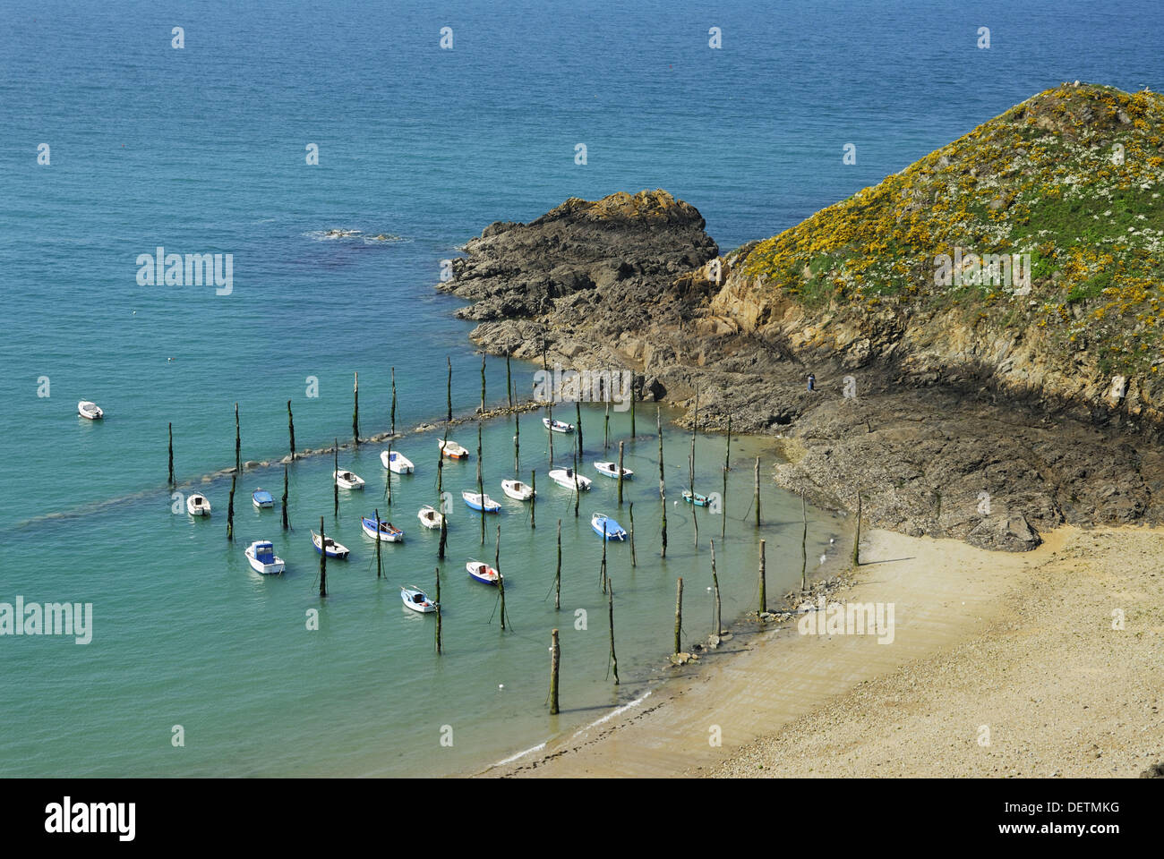 Brittany France The ancient small harbour of Gwin Zegal, boats are tied up  to tree trunks driven into the sand Stock Photo - Alamy
