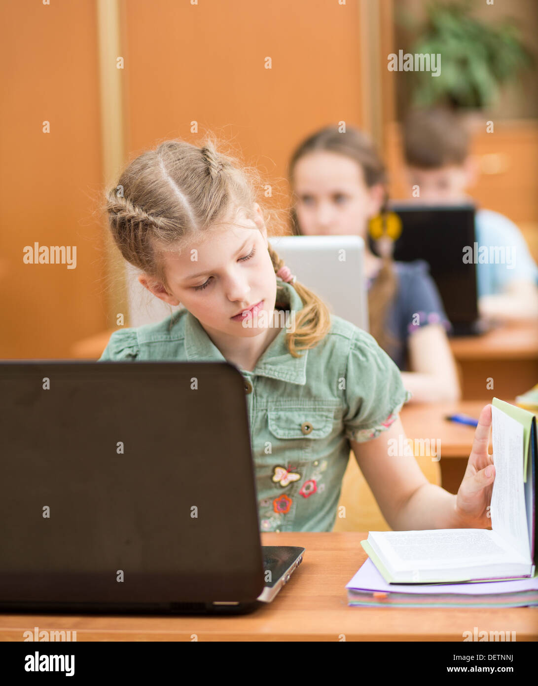 school kids using notebook at lesson Stock Photo Alamy