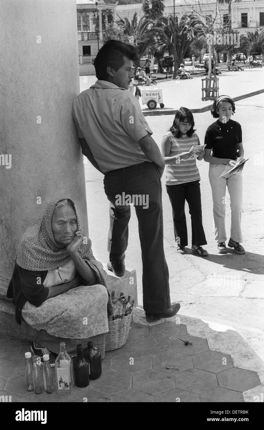 San Cristóbal de las Casas, Mexico. Poverty woman hoping to sell ordinary old bottles to the few American tourists in town. 1970s 1973 HOMER SYKES Stock Photo