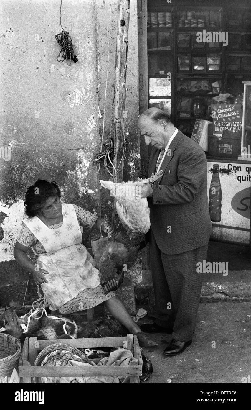 Mexico 1970s  man food shopping checking if the chicken is plump. 1973 Oaxaca de Juárez  HOMER SYKES Stock Photo