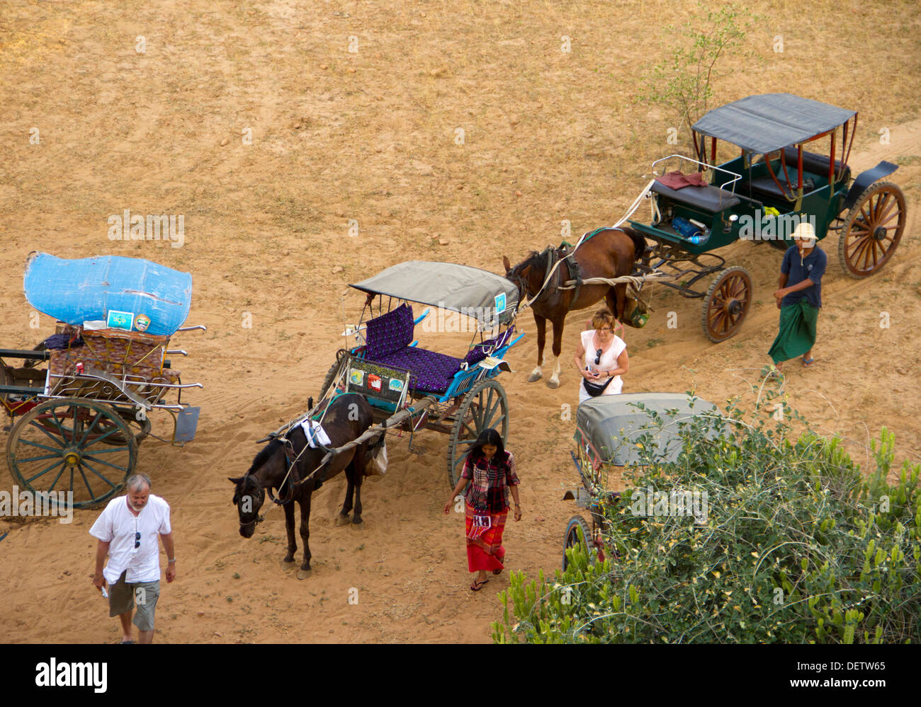 Tourists arrive for sunset in horse cart to Buledi Temple in the central plain of Bagan, Burma. Stock Photo