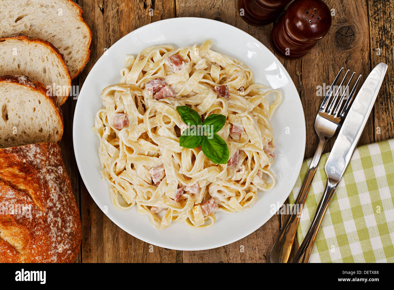 top view of a plate of tagliatelli carbonara, italian cuisine in a traditional restaurant setting Stock Photo