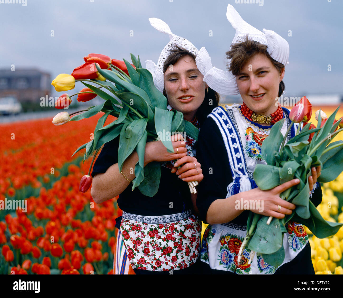 Lisse Holland Girls In Traditional. Costume Holding Tulips Stock Photo