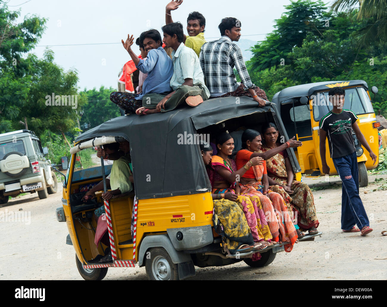 Indian auto rickshaw full of people, with passengers sitting on the roof. Andhra Pradesh, India Stock Photo