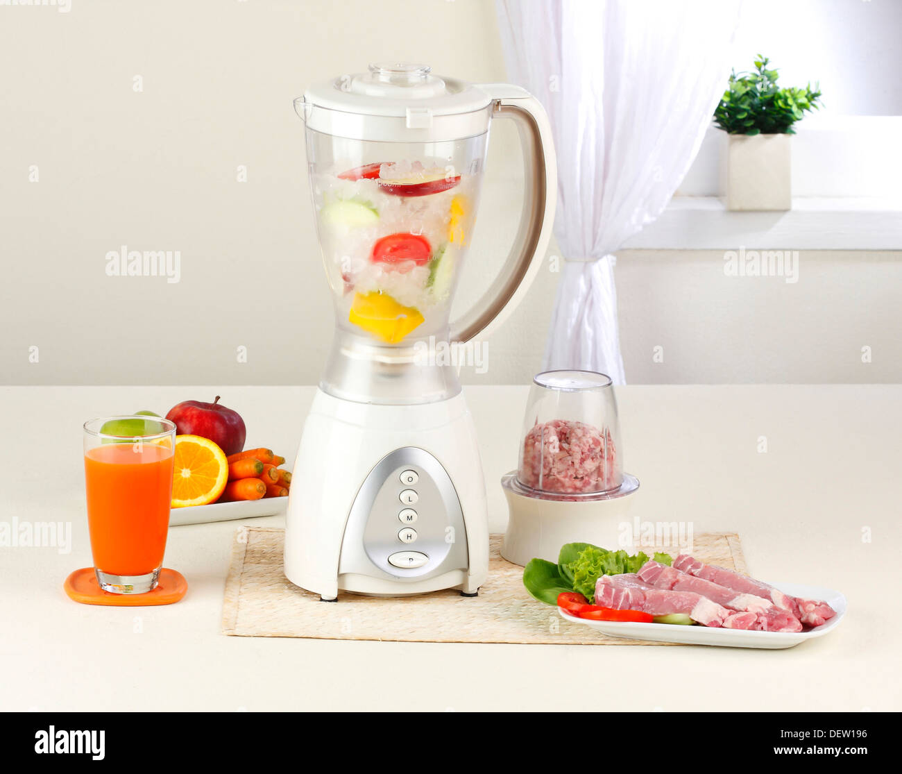 You can make juice and smoothies or blend some pork by using the same blender machine Stock Photo