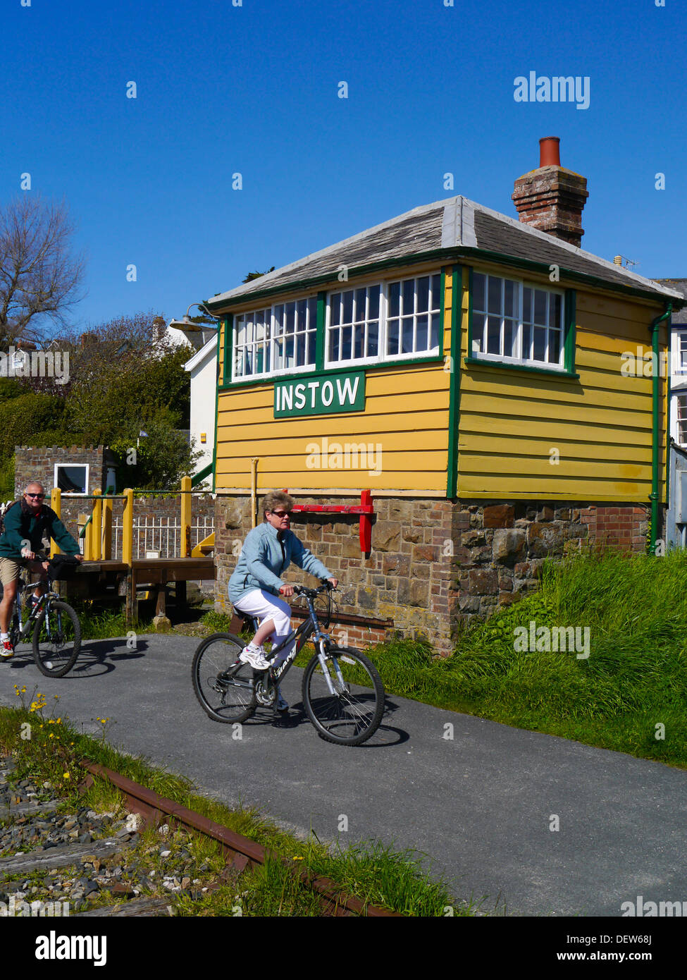 Cyclists passing old signal box on Tarka Trail at Instow Devon England Stock Photo