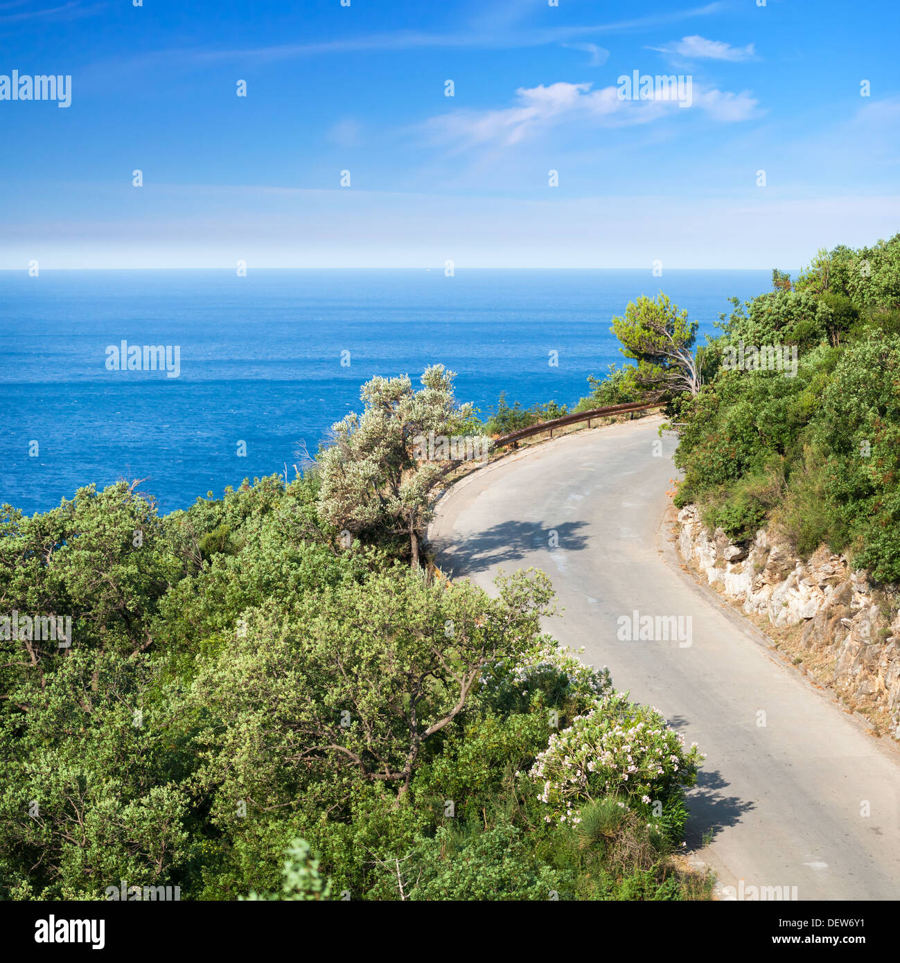 Mountain highway with blue sky and sea on a background Stock Photo
