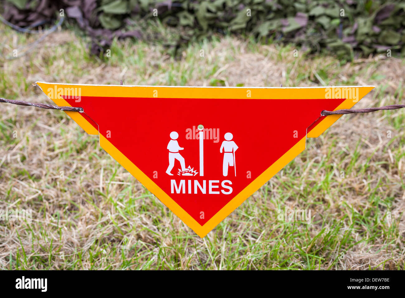 Land mine or minefield danger warning sign in a war zone area Stock Photo