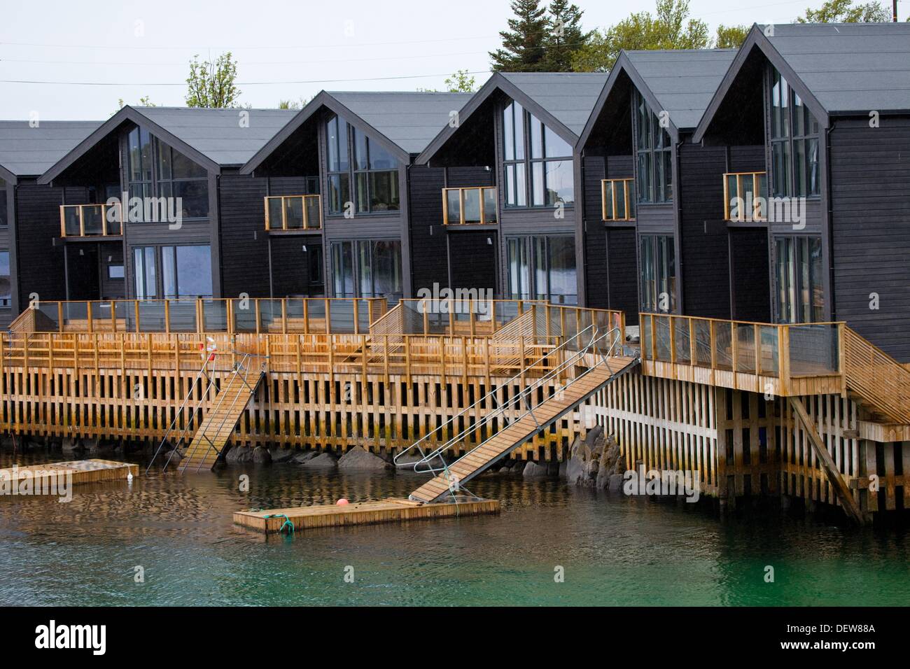 Modern houses built in front of a small fjord near the village of