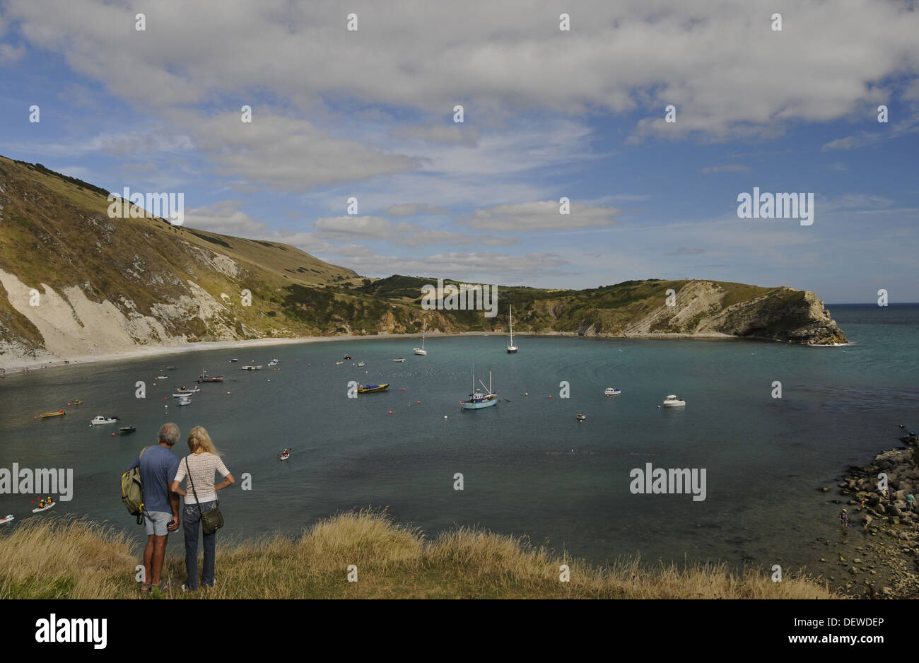 Couple looking out over Lulworth Cove on the  Jurassic Coast Isle of Purbeck Dorset England Stock Photo