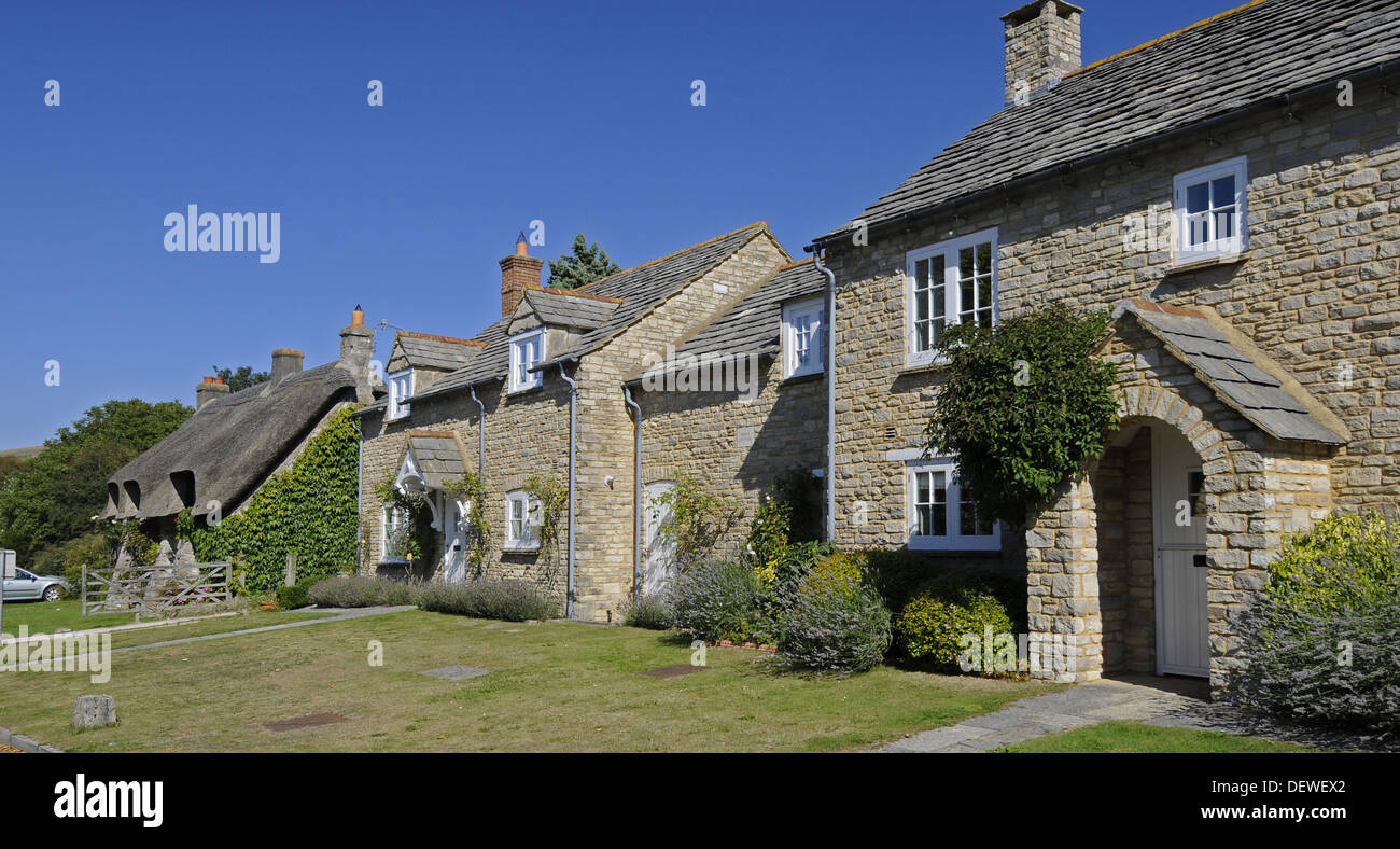 Thatched Cottage and traditional houses in the village of Corfe Isle of Purbeck Dorset England Stock Photo