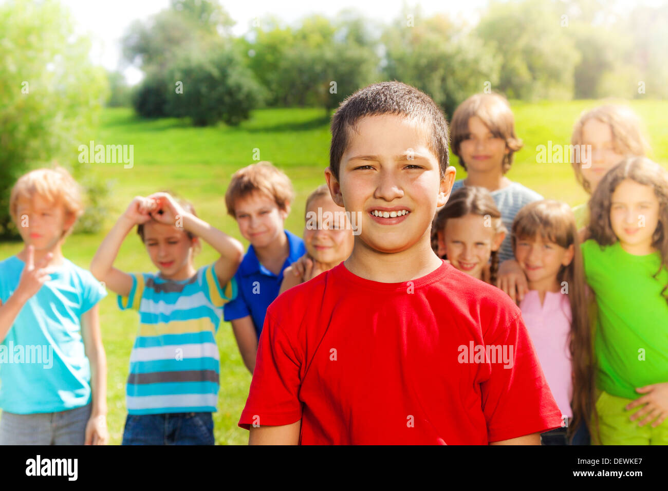 Happy group of people and close portrait one Asian boy in red shirt Stock Photo