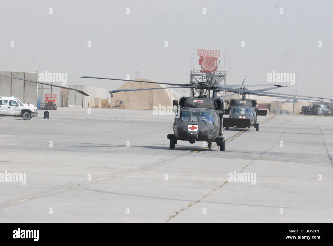 A pair of HH-60M Black Hawk medical evacuation helicopters crewed by members of C Company (DUSTOFF), 3rd Battalion (General Support), 10th Combat Aviation Brigade, Task Force Phoenix, taxi to the patient drop-off location outside Heathe N. Craig Joint The Stock Photo