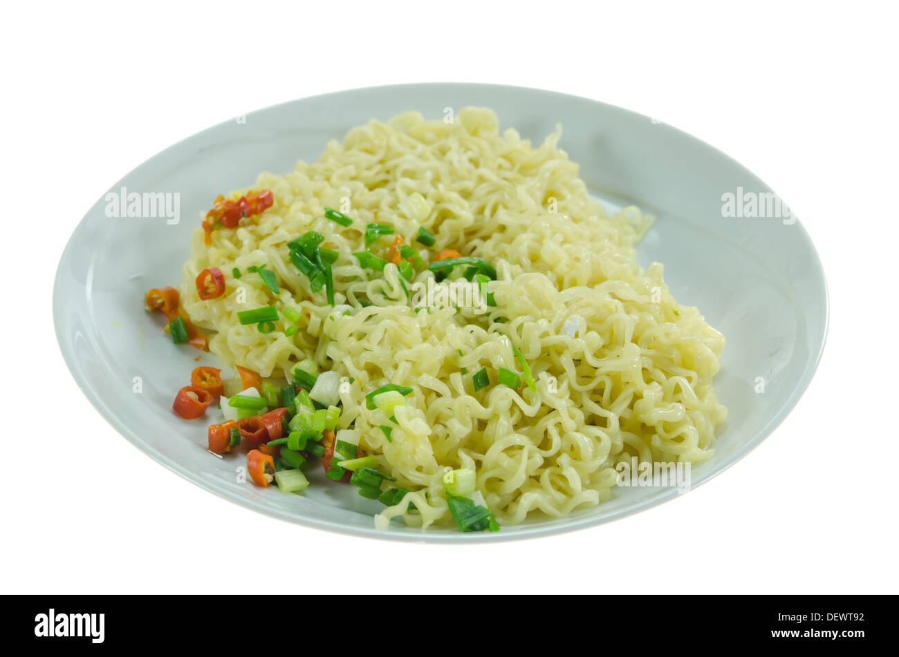 close up cooked instant noodles with chili and vegetable on dish over white background Stock Photo