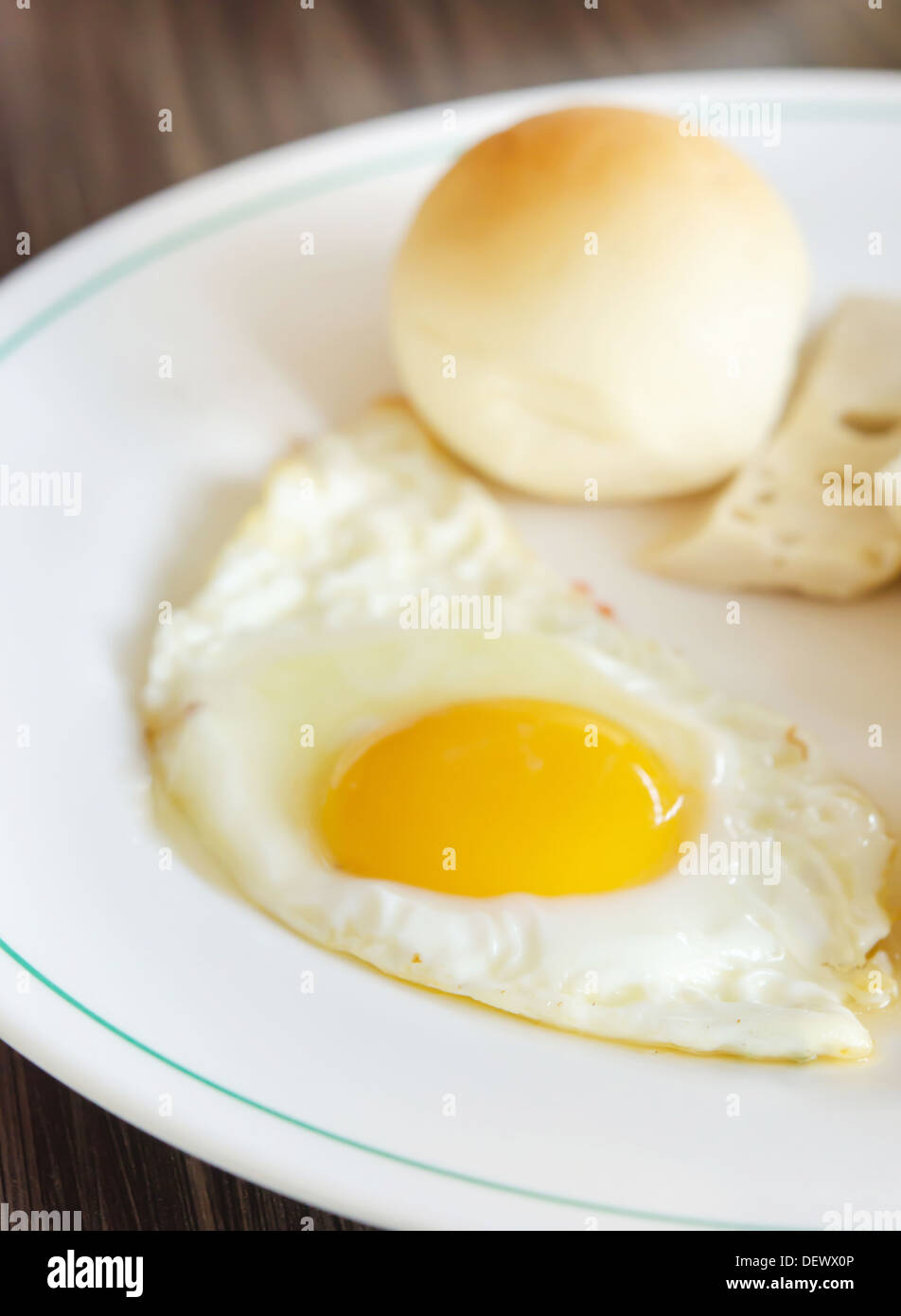 fried egg and bread on white dish Stock Photo