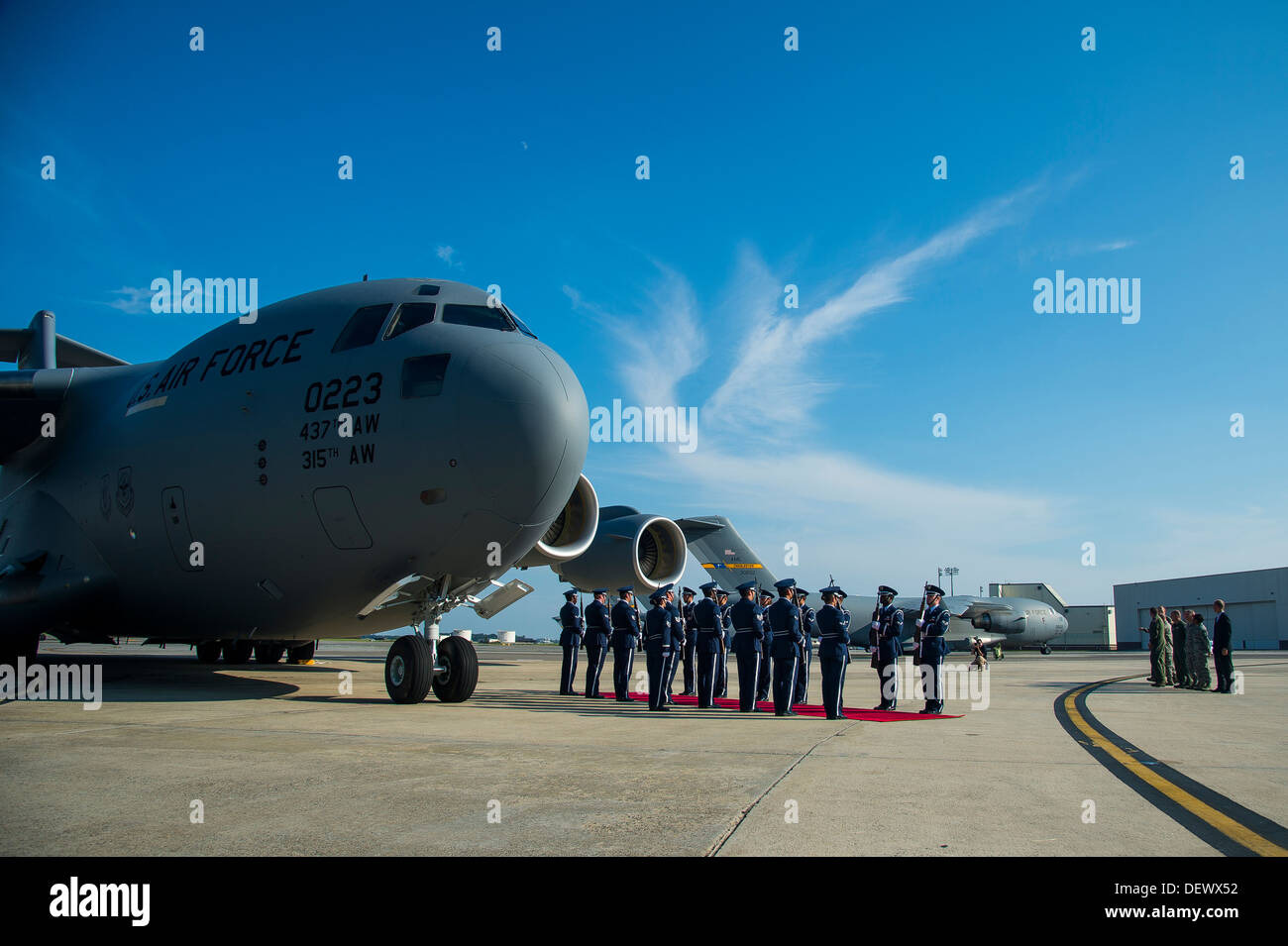 Members of the Joint Base Honor Guard wait by a red carpet for the arrival of the official party during a delivery ceremony Sept. 12, 2013, on the flight line at Joint Base Charleston - Air Base, S.C. This historical event comes more than 20 years after t Stock Photo