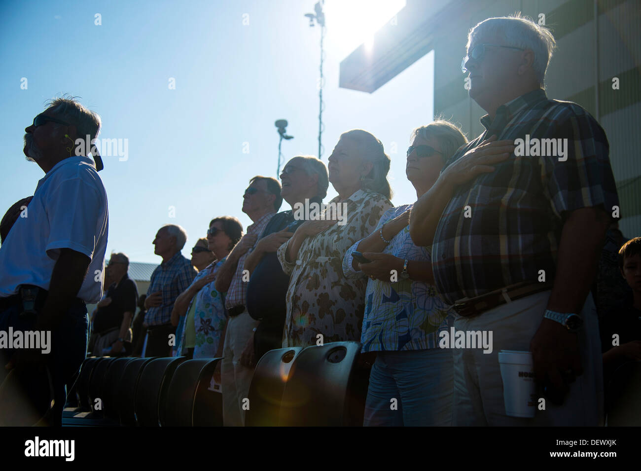 Members of the crowd place their hands over their hearts while the National Anthem plays during a delivery ceremony Sept. 12, 2013, on the flight line at Joint Base Charleston - Air Base, S.C. This historical event comes more than 20 years after the 437th Stock Photo