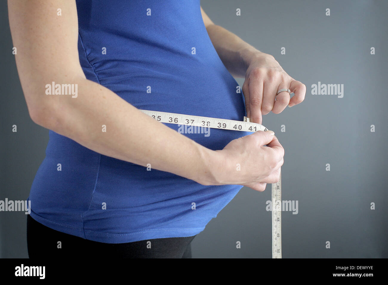Pregnant lady measuring her baby bump Stock Photo Alamy