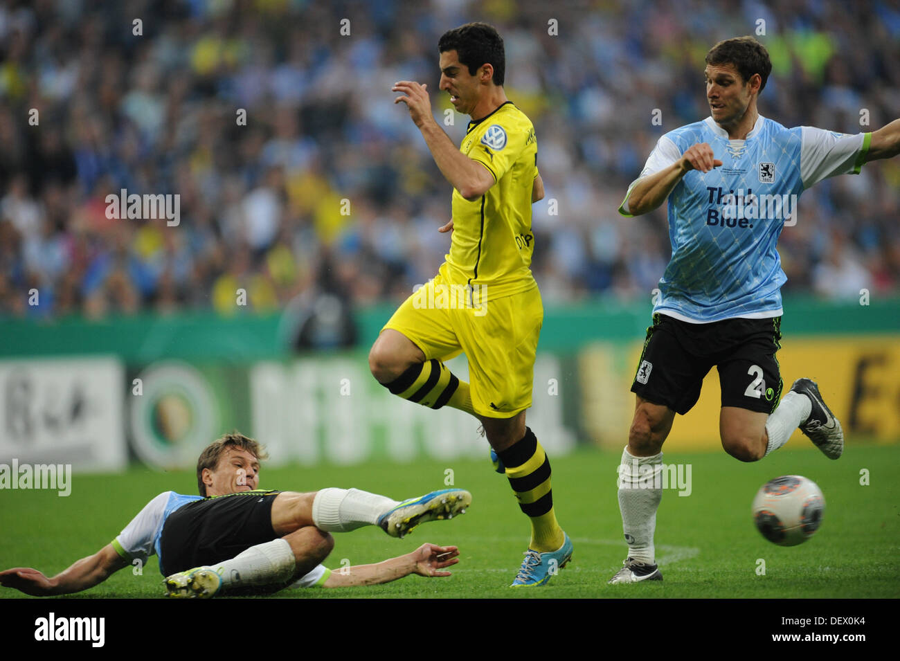Munich, Germany. 24th Sep, 2013. Kai Buelow (L) and Moritz Volz (R) of Munich cut off Henrich Mchitarjan from the ball during the DFB Cup second round match TSV 1860 Munich vs. Borussia Dortmund at the Allianz Arena in Munich, Germany. Credit:  dpa picture alliance/Alamy Live News Stock Photo