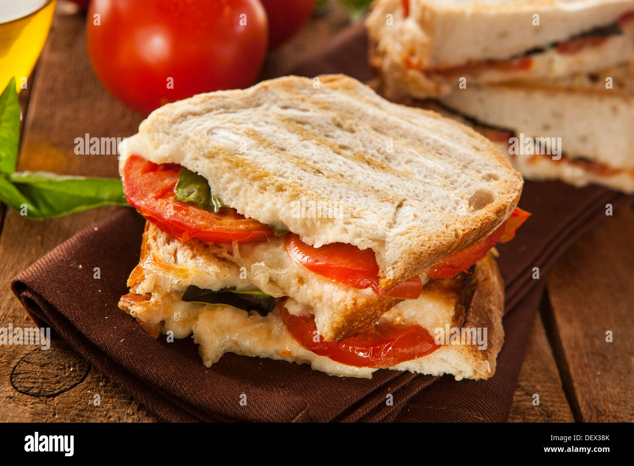Homemade Tomato and Mozzarella Panini with Basil Stock Photo