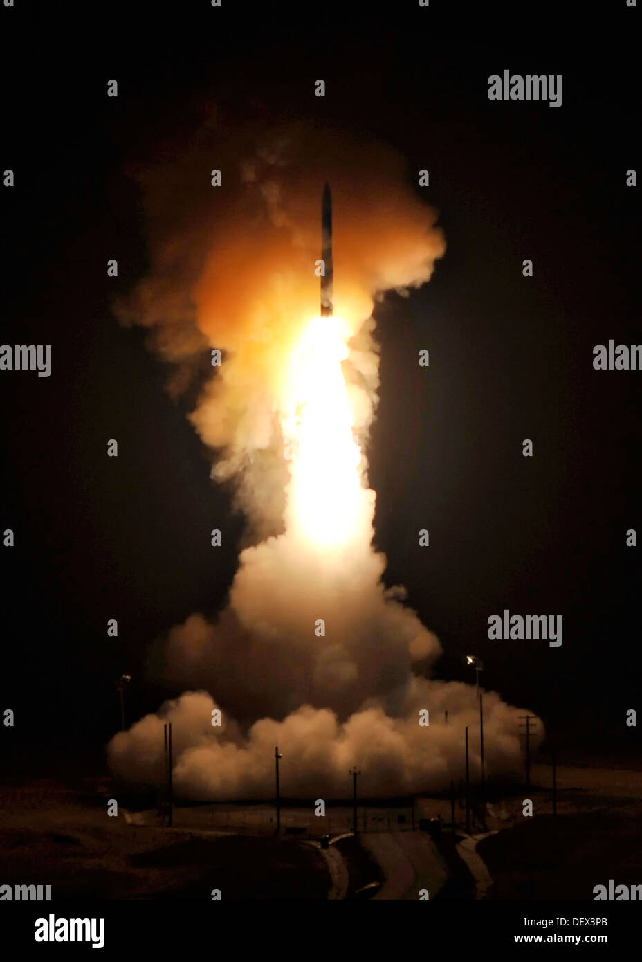 An Air Force Global Strike Command Minuteman III intercontinental ballistic missile with a simulated warhead is launched during an operational test at September 22, 2013 from Launch Facility 10 Vandenberg, CA. Stock Photo