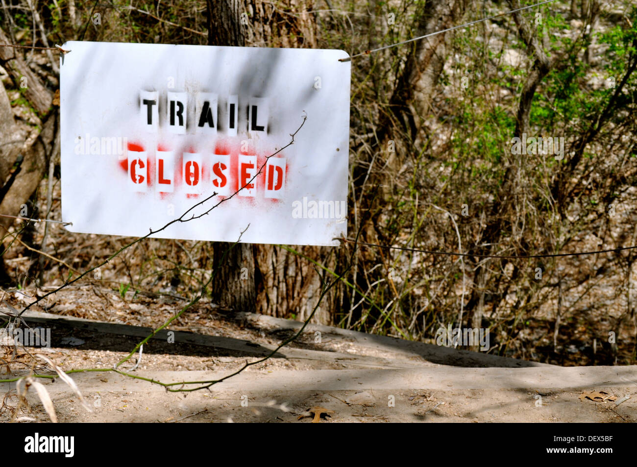 Sign trail closed in woods Stock Photo - Alamy
