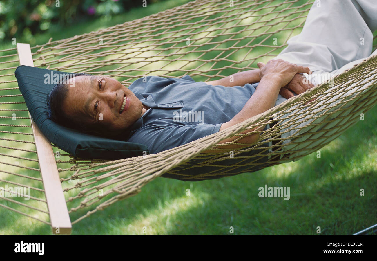 Senior man relaxing in hammock hi-res stock photography and images - Alamy