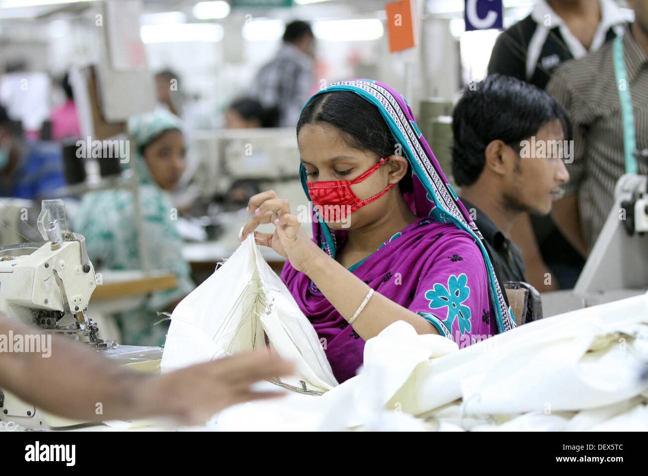 Dhaka, Bangladesh  . 24th Sep, 2013. BANGLADESH, Dhaka : A Bangladeshi woman works in a garments factory in Ashulia Savar in Dhaka on September 24, 2013. Stock Photo