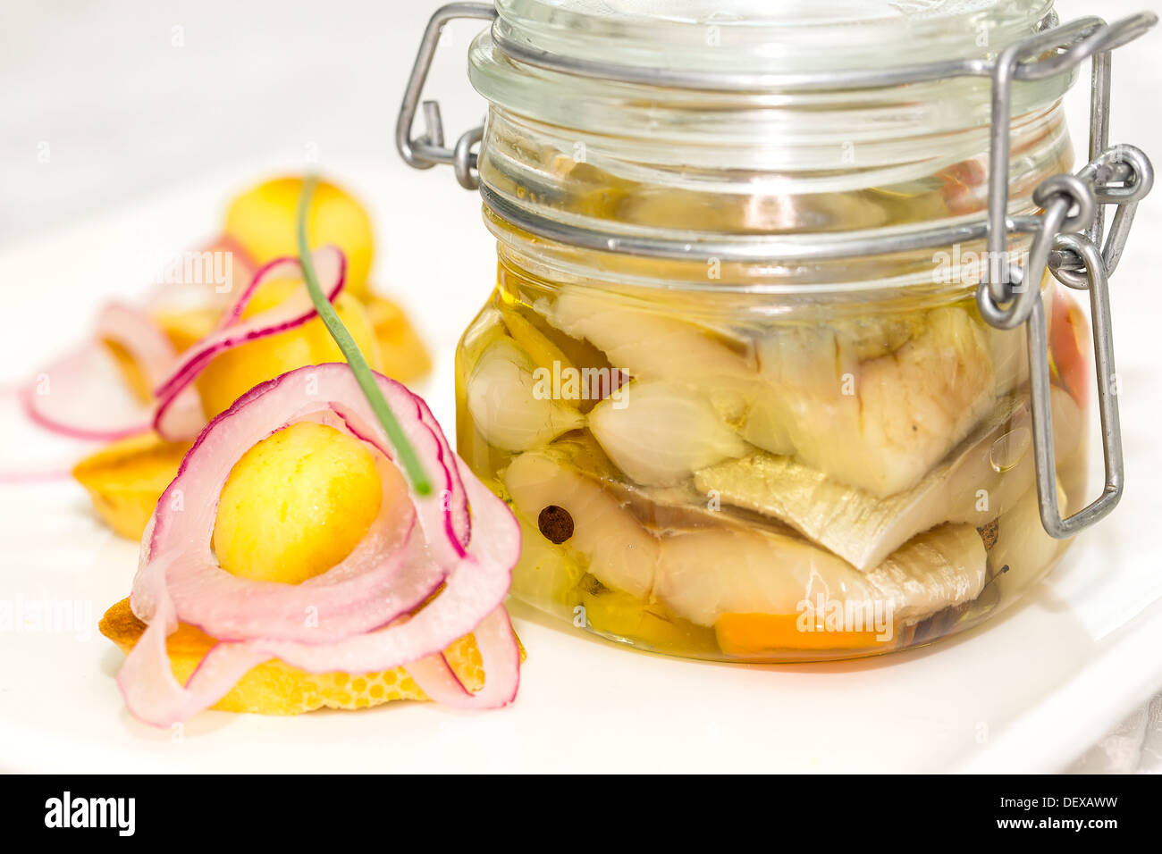 pickled herring in a glass jar with potato canapes Stock Photo Alamy