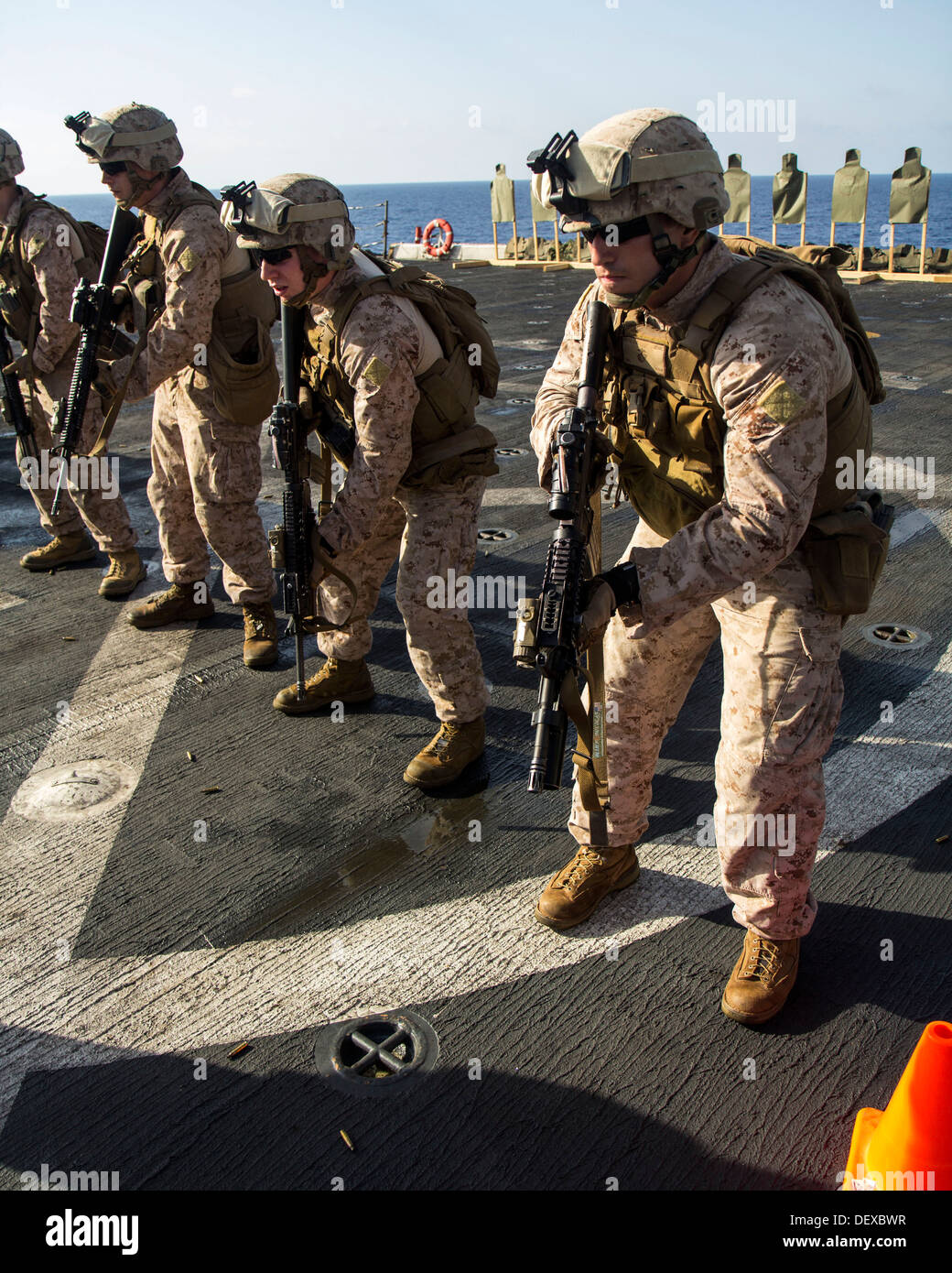 U.S. Marines assigned to Company L, Battalion landing Team 3/2, 26th Marine Expeditionary Unit (MEU), prepare to fire on targets during a live fire exercise on the flight deck of the USS San Antonio (LPD 17), at sea, Sept. 12, 2013. The 26th MEU is a Mari Stock Photo