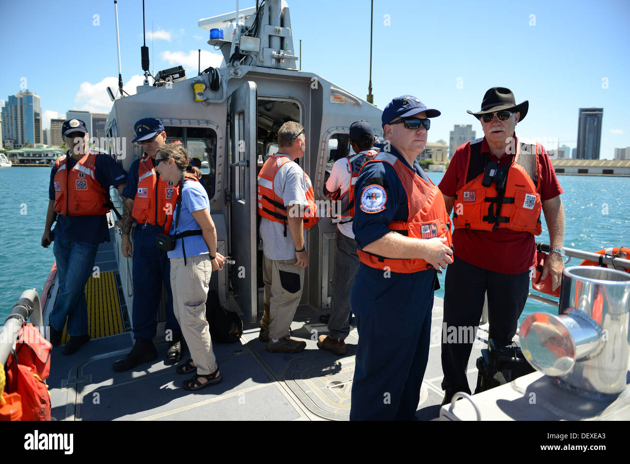 Crewmembers from the Coast Guard National Strike Force head to their next location to use a water quality instrument used to monitor depleted oxygen and pH levels in Honolulu Harbor, Honolulu Sept. 15, 2013. Personnel from the Coast Guard, U.S. Environmen Stock Photo