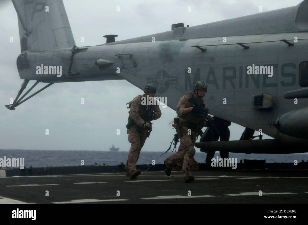 U.S. Marines with Command Element, 31st Marine Expeditionary Unit(MEU) board the USNS Rappahannock during a Visit Board Search and Seizure(VBSS) exercise, at sea, September 15, 2013. The 31st MEU regularly performs amphibious training such as the VBSS to Stock Photo