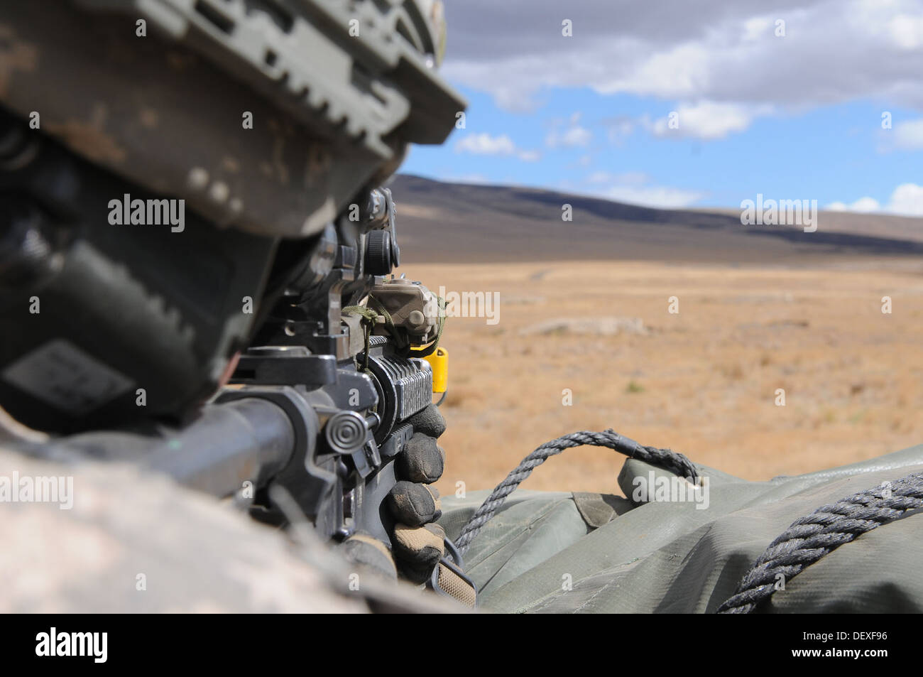 U.S. Army Sgt. Kenton Miller, 5th Battalion, 20th Infantry Regiment, 3rd Stryker Brigade Combat Team, 2nd Infantry Division, takes aim at a simulated target with an M4 carbine during a joint platoon exercise at the Yakima Training Center, Wash., Sept. 16, Stock Photo