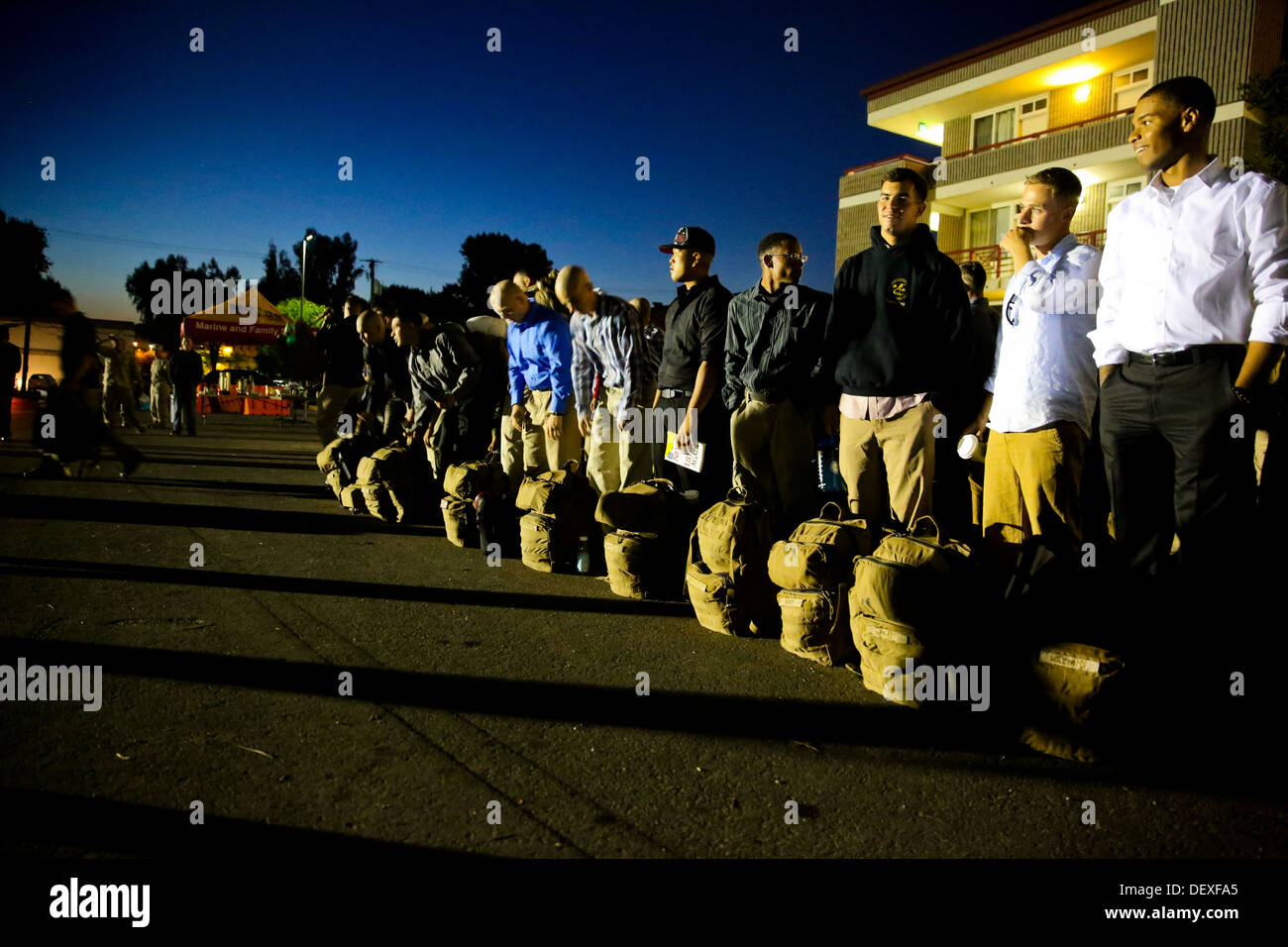 Marines and sailors with Bravo Company, 1st Battalion, 1st Marine Regiment, take accountability before boarding a bus for deployment at the Camp Horno parade deck here, Sept. 14, 2013. Marines with the company will provide site security at an embassy in t Stock Photo