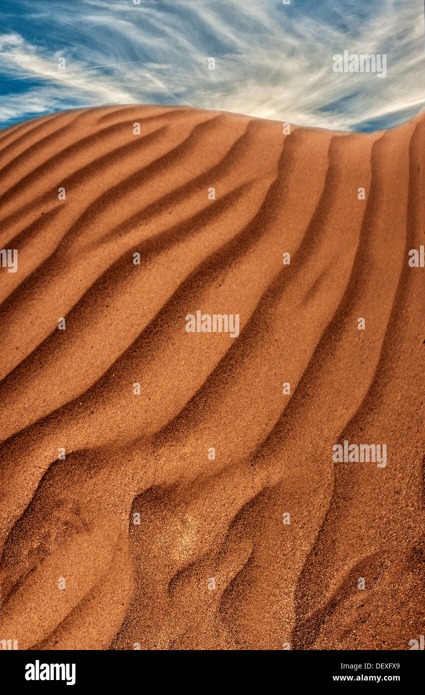 An  editorial style image of a Navajo sandstone sand dune,vertical image,sky was added. Pete Turner style image Stock Photo