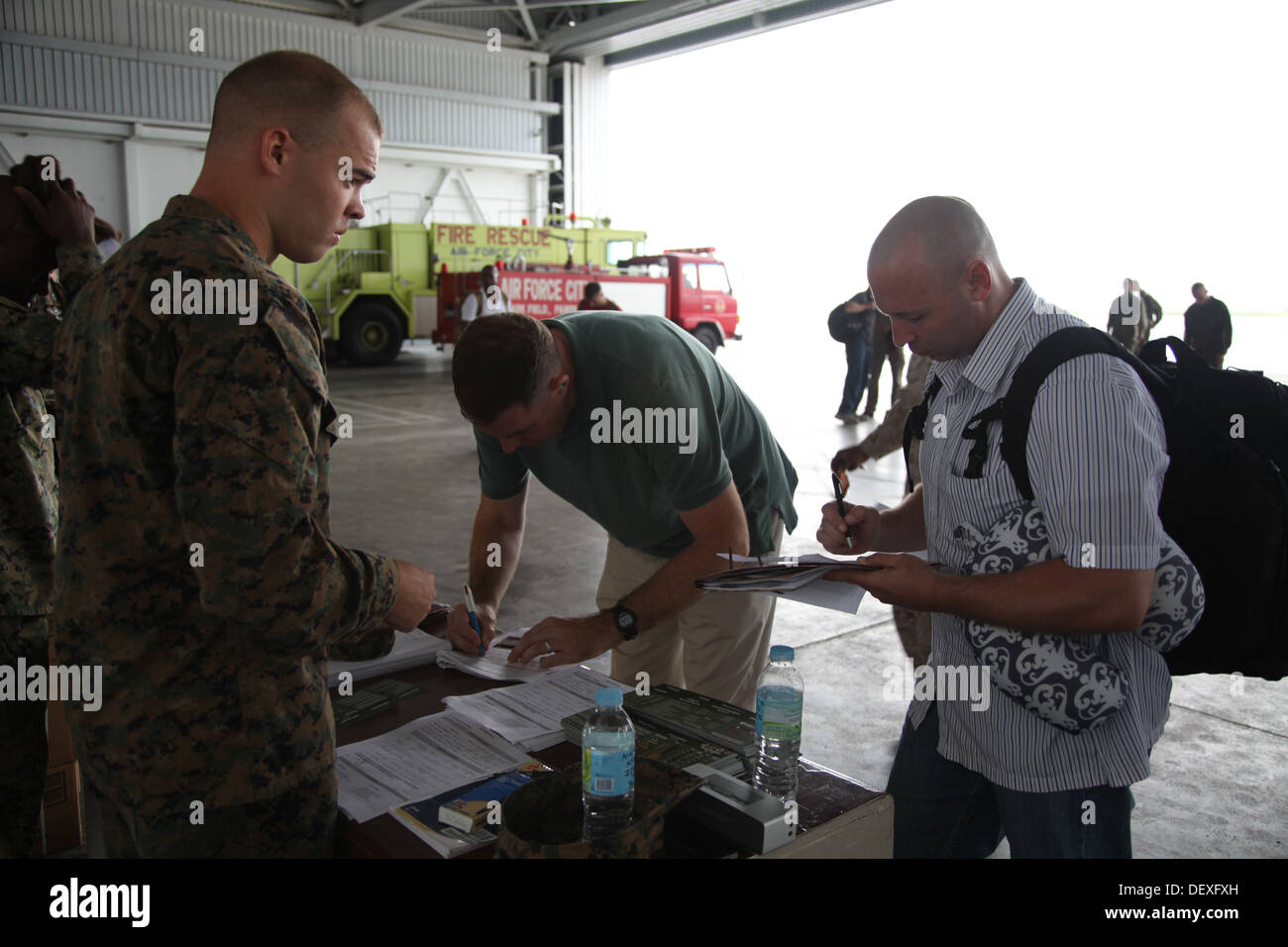 Cpl. Trevor Felten assists Marines with the check-in process for Amphibious Landing Exercise 2014 at Clark Air Field, Pampanga, Stock Photo