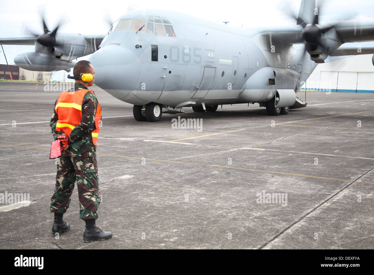 Philippine Air Force Tech. Sgt. Seno Nellas waits as a KC-130 Hercules aircraft arrives Sept. 14 carrying Marines for Amphibious Landing Exercise 2014 at Clark Air Field, Pampanga, Republic of the Philippines. Nellas is the noncommissioned officer in char Stock Photo