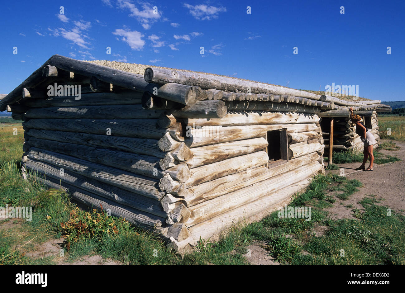 Elk266-1170 Wyoming, Grand Teton National Park, Cunningham Cabin, 1895, with park visitor Stock Photo